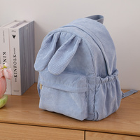 Sac à dos en velours côtelé personnalisé en gros avec oreilles de lapin, poche avant zippée, poches latérales à cordon de serrage, bretelles réglables
