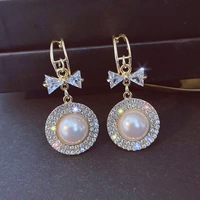 Pendientes de perlas de imitación con lazo de temperamento para mujer, nicho redondo de moda y versátil y pendientes personalizados al por mayor