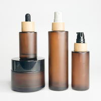 Ensemble de bouteilles en verre de luxe de 30 ml 50ml 100ml Flacon cosmétique en verre dépoli ambré avec vaporisateur à pompe en bambou