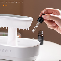 Diffuseur d'huiles essentielles LED 7 couleurs avec effet pluie, humidificateur d'air intelligent à brume froide, bruit blanc et micro-paysage végétal en forme de goutte de pluie