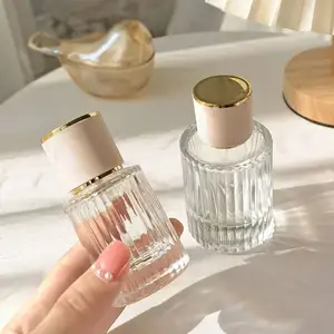 Low MOQ Wholesale Empty Luxury 50ml Round Clear 75ml Glass Perfume Bottle With Unique Sprayer