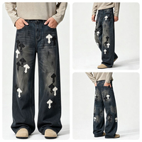 Jeans amples à coupe croisée de style américain haut de gamme pour hommes, avec patchs en cuir croisés et motifs brodés