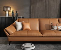Canapé en cuir de style minimaliste pour le salon. Les coussins de siège sont de forme généreuse. Couleur orange. Ensemble de canapés 1+3+ottoman.