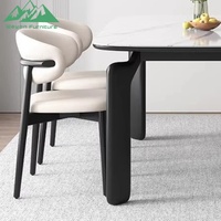 Ensemble de table à manger Wayon moderne avec plateau en marbre blanc, pieds architecturaux noirs, chaises rembourrées