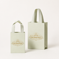 Vente en gros de mini sacs-cadeaux de luxe imprimés sur mesure Papier d'art écologique blanc et rouge pour bijoux et montres pour marque