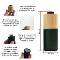 Flacon compte-gouttes en verre avec bouton-poussoir en bambou personnalisé de luxe avec couvercle en bambou pour l'emballage d'huiles essentielles, de sérums et de cosmétiques