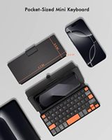 Keyboard Mini Universal BT dengan tombol navigasi oranye dan dudukan serbaguna untuk Android/iOS/Windows