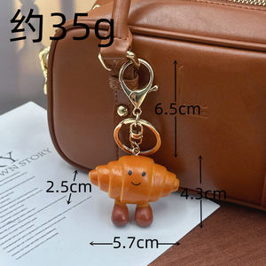 Breloque de sac et porte-clés en PVC, mignonne, légère, en forme de pain, de bretzel ou de croissant, avec nœud, accessoire de bijouterie pour sac à dos - Product Image 5