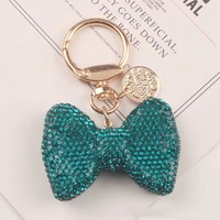 Petit cadeau mignon animal ours porte-clés avec arc et diamant porte-clés en gros Creative Care ours poupée pendentif en métal