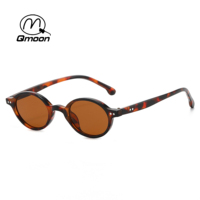 Qmoon Vente en gros de lunettes de soleil ovales rétro noires en PC, protection UV400, lunettes de soleil tendance, monture ronde légère pour hommes et femmes