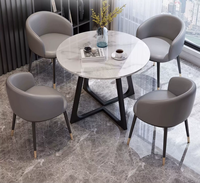 Ensemble table et chaises effet pierre moderne et compact pour réunions d'affaires et réception de clients, usage professionnel en bureau