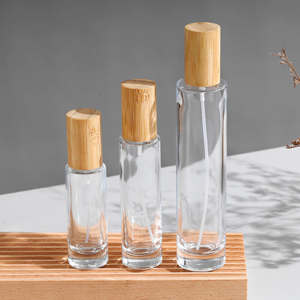 ผู้ผลิตขายส่งขวดน้ำหอมแก้วใสทรงกระบอกขนาด 30 มล. 50 มล. 100 มล. แบบหนา พร้อมฝาไม้ - Product Image 3