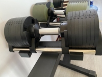 Mancuerna ajustable de 100 LB con selección de peso mediante perilla, construcción robusta, ideal para desarrollo muscular y entrenamientos de cuerpo completo.