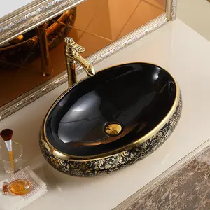 อ่างล้างมือสไตล์วินเทจหรูหรา,อ่างล้างมือสีทองและสีดำอ่างล้างมือในห้องน้ำทรงวงรีด้านบนเคาน์เตอร์โต๊ะ