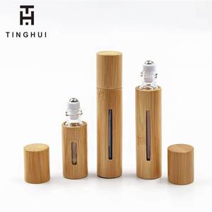 Envase cosmético de alta gama, botella de perfume de bambú de 10 ml con bola giratoria, botella para aceites esenciales. - Product Image 1