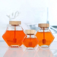 Tarro de miel único con cuchara de madera, tarro de vidrio hexagonal al por mayor para miel