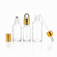 Flacon compte-gouttes en verre vide avec col fileté, collier doré et insert à bille blanche pour emballage cosmétique d'huiles essentielles et de sérums