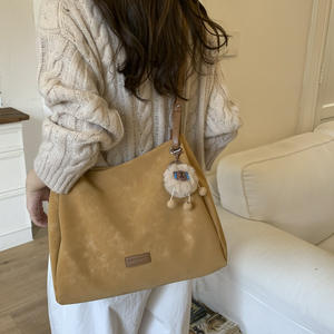 Brownish-<b>yellow</b> suede shoulder <b>bag</b> with a sweet, plush charm; women's handbag. - Product Image 4