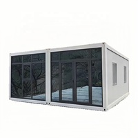 Maison conteneur préfabriquée de 20 pieds avec toit incliné à drainage élevé, mur-rideau en verre, design moderne et détachable pour un confort de vie