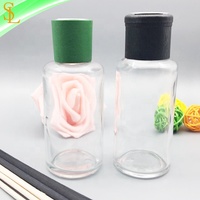 Bouteilles en verre de diffuseur rondes de 100ml à vendre Bouteille vide de diffuseur de roseau d'arôme avec le chapeau et le bouchon