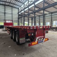 Semi-remorque plateau tri-essieux robuste pour le transport de marchandises en surcharge et de composants industriels, avec contrôle qualité strict