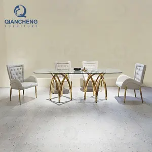 Çin lüks yemek masası ve sandalyeler vintage cam sertleştirilmiş cam üst yemek masası 8 bakıcısı metal 8K altın ss çelik mobilya