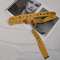 Cette ceinture en toile tissée entièrement blanche, au style audacieux, avec boucle à plaque et œillets métalliques argentés sur toute la longueur, offre une ambiance cool et punk pour le streetwear.