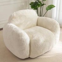 Fauteuil pouf confortable en forme de galet, avec dossier et accoudoirs de soutien, revêtement en velours, design moderne, garnissage en linge déchiqueté, pour salon
