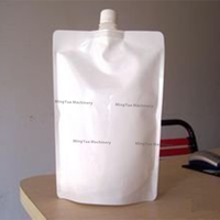 Machine de remplissage et de bouchage semi-automatique pour sachets à bec verseur de boissons, miel, liquides et détergents
