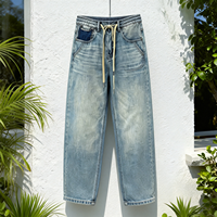 Jean en denim tissé délavé bleu vintage, style américain, coupe droite, taille mi-haute, effet usé, décontracté, écologique, automne-hiver
