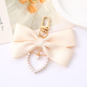 Bagages créatifs exquis de haute qualité accessoires de téléphone portable personnalisés porte-clés en gros de noeud de papillon d'amour de perle - Product Image 4