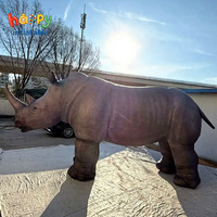 Accessoires de cinéma : Rhinocéros gonflable géant et réaliste pour événements sur le thème de la migration animale, décor de scène gonflable