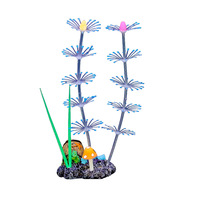 La décoration moderne de l'aquarium comprend une résine durable, un plastique, un silicone, des champignons fluorescents souples, des plumes, des coraux et des plantes aquatiques