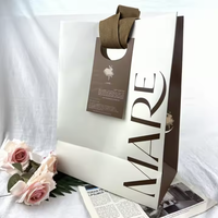 Cadeau en gros de luxe à vendre sac à provisions ruban de papier enduit poignée emballage recyclable OEM montre bijoux lunettes