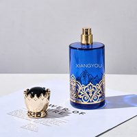 Flacon de parfum en verre de luxe en gros avec bouchon doré orné d'une couronne, idéal pour l'emballage de parfums premium du Moyen-Orient de 100 ml