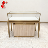 Vitrine de présentation de bijoux en verre avec portes coulissantes, serrures, cadre en acier inoxydable doré champagne brossé, plateau crème