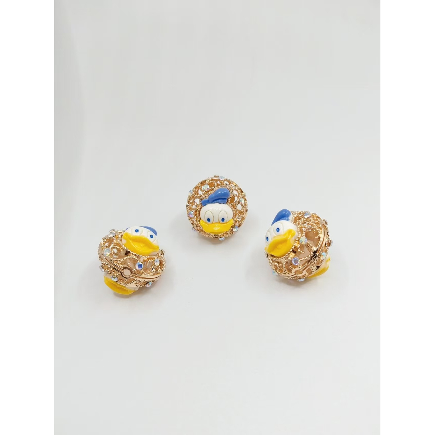 Round, gold-plated Donald Duck