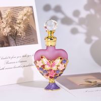 Flacon vide en verre pour huiles essentielles et parfums de voyage, en forme de cœur, avec texture givrée, motif papillon et fleur émaillés