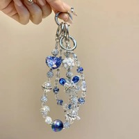Breloque de téléphone papillon bleu en strass et perles, pendentif de sac artisanal lourd, cordon de poignet, cadeau bijou pour femme