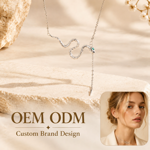 สร้อยคอจี้รูปงูสแตนเลสสตีลขายส่งแบบ OEM ODM พร้อมจี้รูปตาประดับเพชร CZ สีเขียวและพู่ห้อยรูปเข็ม เครื่องประดับสำหรับผู้หญิง - Product Image 1