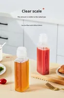 Bouteille à huile manuelle en plastique pour cuisine, design à extrémité pointue, bouteille à huile à presser avec échelle et couvercle pour la cuisine