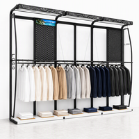 Système d'affichage mural pour vêtements en métal noir à dessus incurvé, avec boîte lumineuse LED, logo et panneau perforé sur mesure
