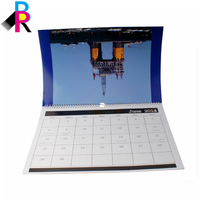 Nouveau modèle de calendrier mural en papier style vintage avec cadre photo et reliure spirale, produit transfrontalier très vendu, idéal pour le commerce centralisé et comme cadeau.