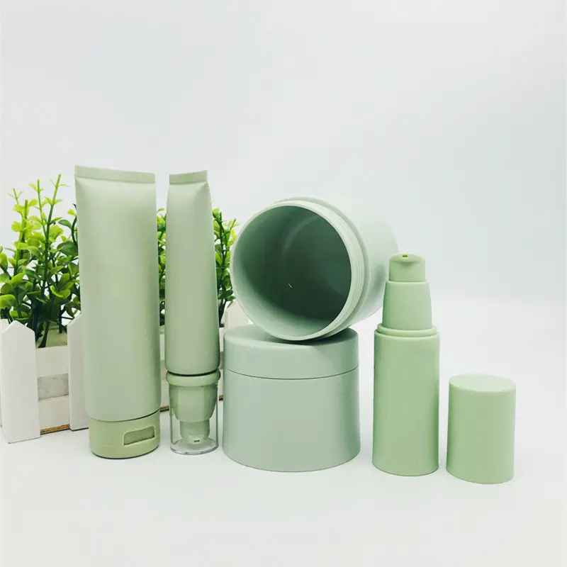 Vide luxe mat vert soins de la peau cosmétiques emballage ensemble en plastique crème pot lotion bouteille pour crème pour le visage