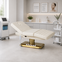 Lit de beauté électrique à 3 moteurs, colonne dorée brossée, base lumineuse LED chaude, trou pour le visage, pour thérapie, salon, spa, microblading, clinique