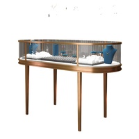 Vitrine à bijoux incurvée avec éclairage LED, couleur personnalisable, en verre et acier inoxydable, design or et jade, pour la présentation de bijoux, montres et cosmétiques