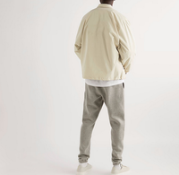 Coupe-vent imperméable en polyester et coton floqué brodé d'un écusson chenille personnalisé OEM Veste légère pour entraîneurs pour hommes