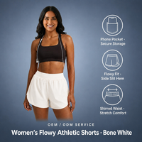 Shorts athlétiques fluides blanc cassé pour femmes avec fente latérale et poche téléphone sécurisée, coupe ample, fabricant de vêtements OEM ODM