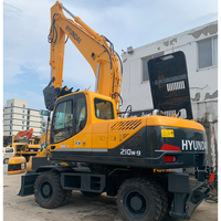 Excavatrice sur pneus Hyundai R210W-9 d'occasion 100% coréenne, 21 tonnes, avec moteur Cummins, pompe et PLC, modèle 2023, équipement pour travaux de terrassement