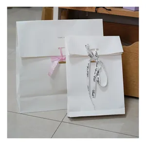 Eco friendly custom logo pieghevole shopping bag abbigliamento cosmetici confezione regalo bianco busta di carta kraft con nastro bowknot